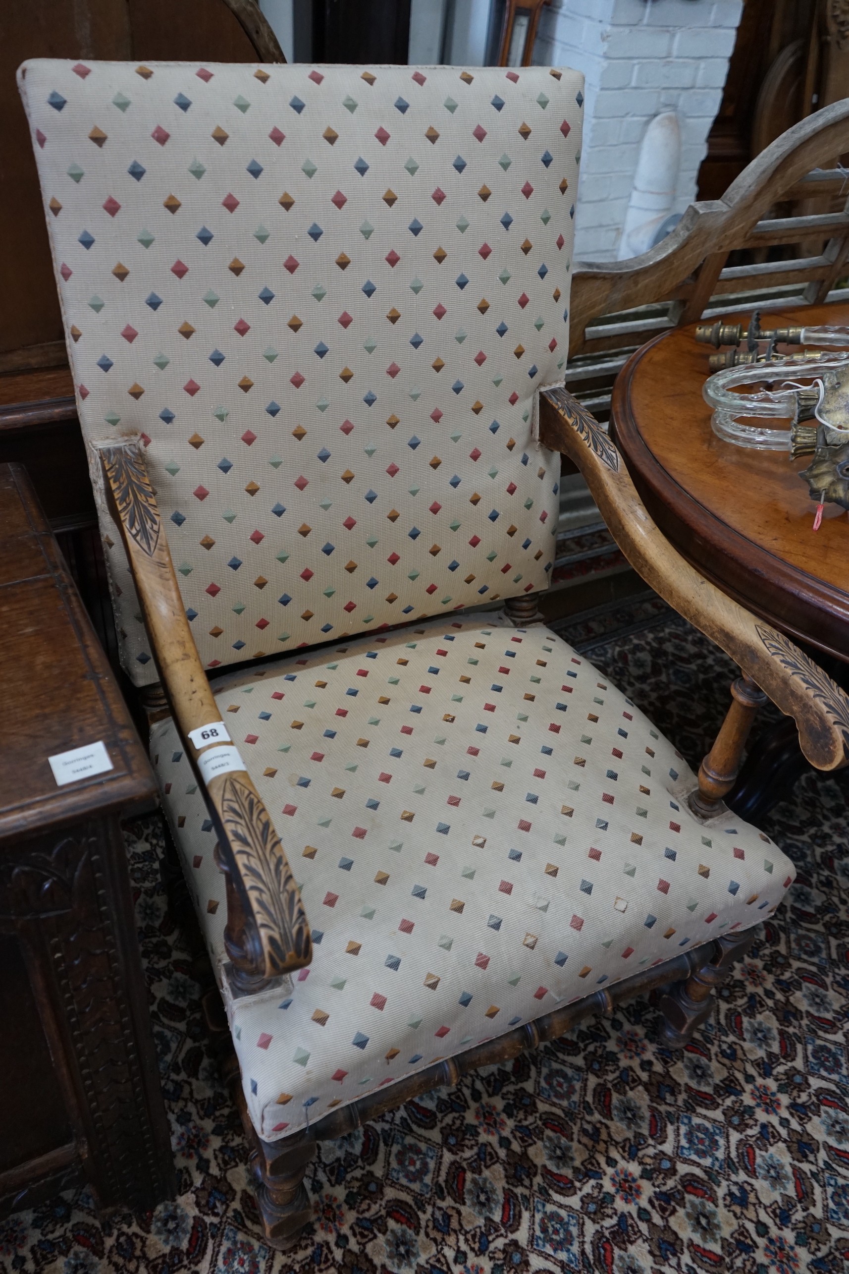 A French carved walnut upholstered elbow chair, width 61cm, depth 54cm, height 110cm